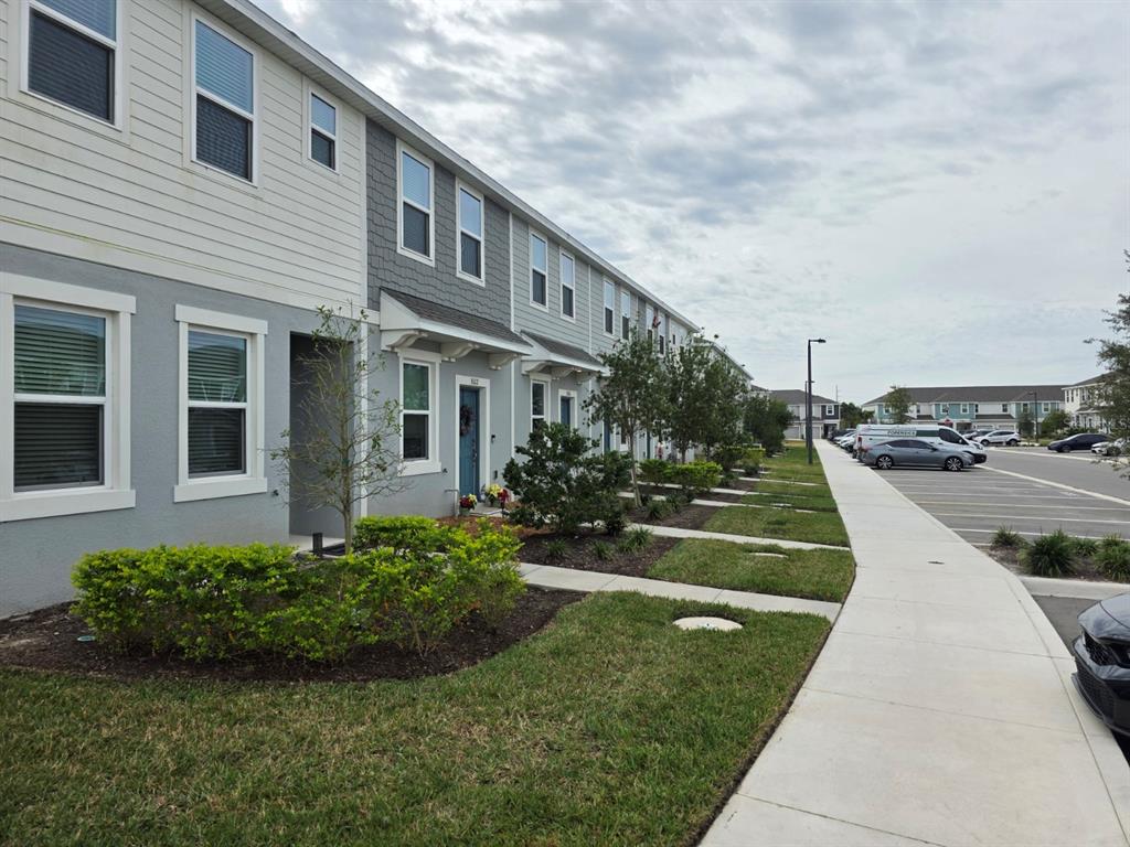 3318 Composition Street Kissimmee, FL 34758 - Photo 27 of 28 a front view of a house with a yard