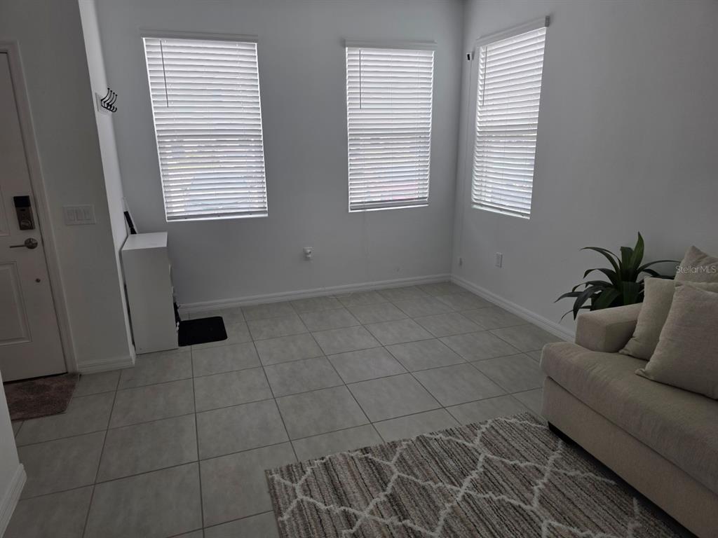3318 Composition Street Kissimmee, FL 34758 - Photo 3 of 28 a living room with furniture and a window