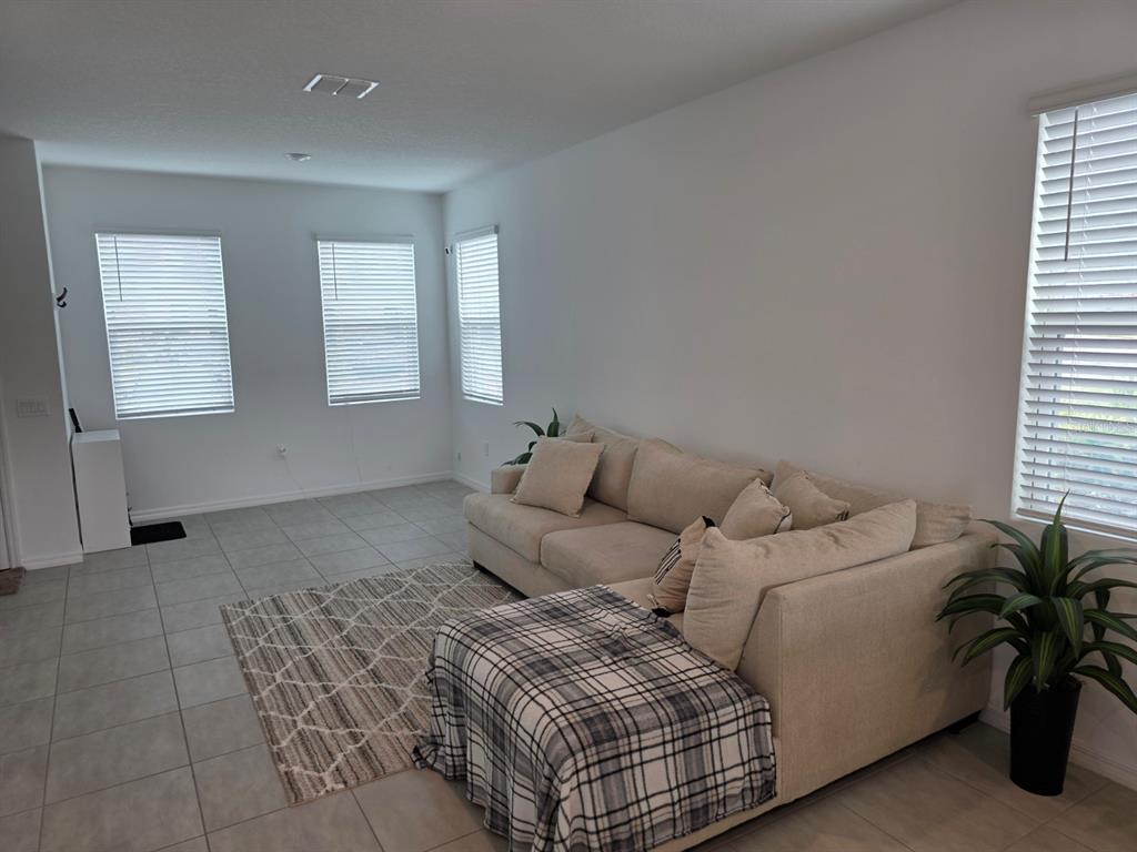 3318 Composition Street Kissimmee, FL 34758 - Photo 4 of 28 a living room with furniture and a potted plant