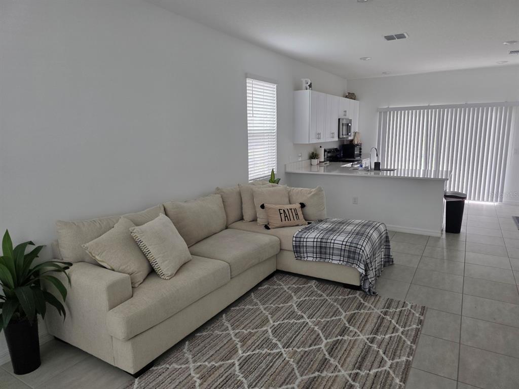 3318 Composition Street Kissimmee, FL 34758 - Photo 5 of 28 a living room with furniture and a large window