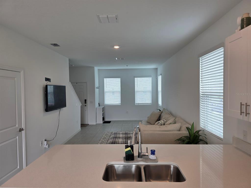 3318 Composition Street Kissimmee, FL 34758 - Photo 8 of 28 a kitchen with a sink and living room