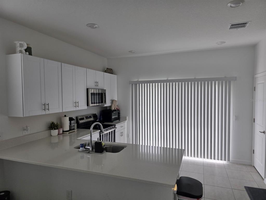 3318 Composition Street Kissimmee, FL 34758 - Photo 10 of 28 a view of a workspace with a couch