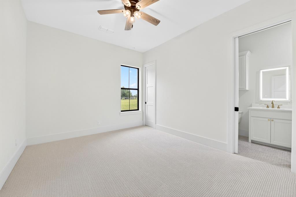 10373 Bobbie Lane Pilot Point, TX 76258 - Photo 21 of 40 One of 3 secondary bedrooms located downstairs with ensuite full bath