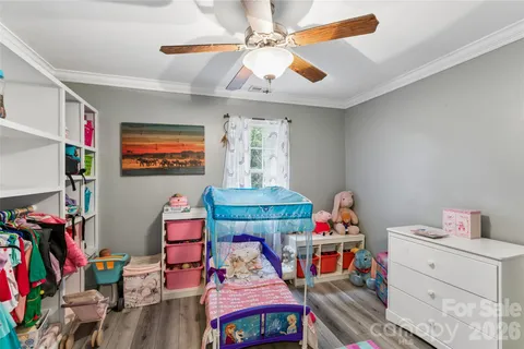 a bedroom with furniture and a baby crib