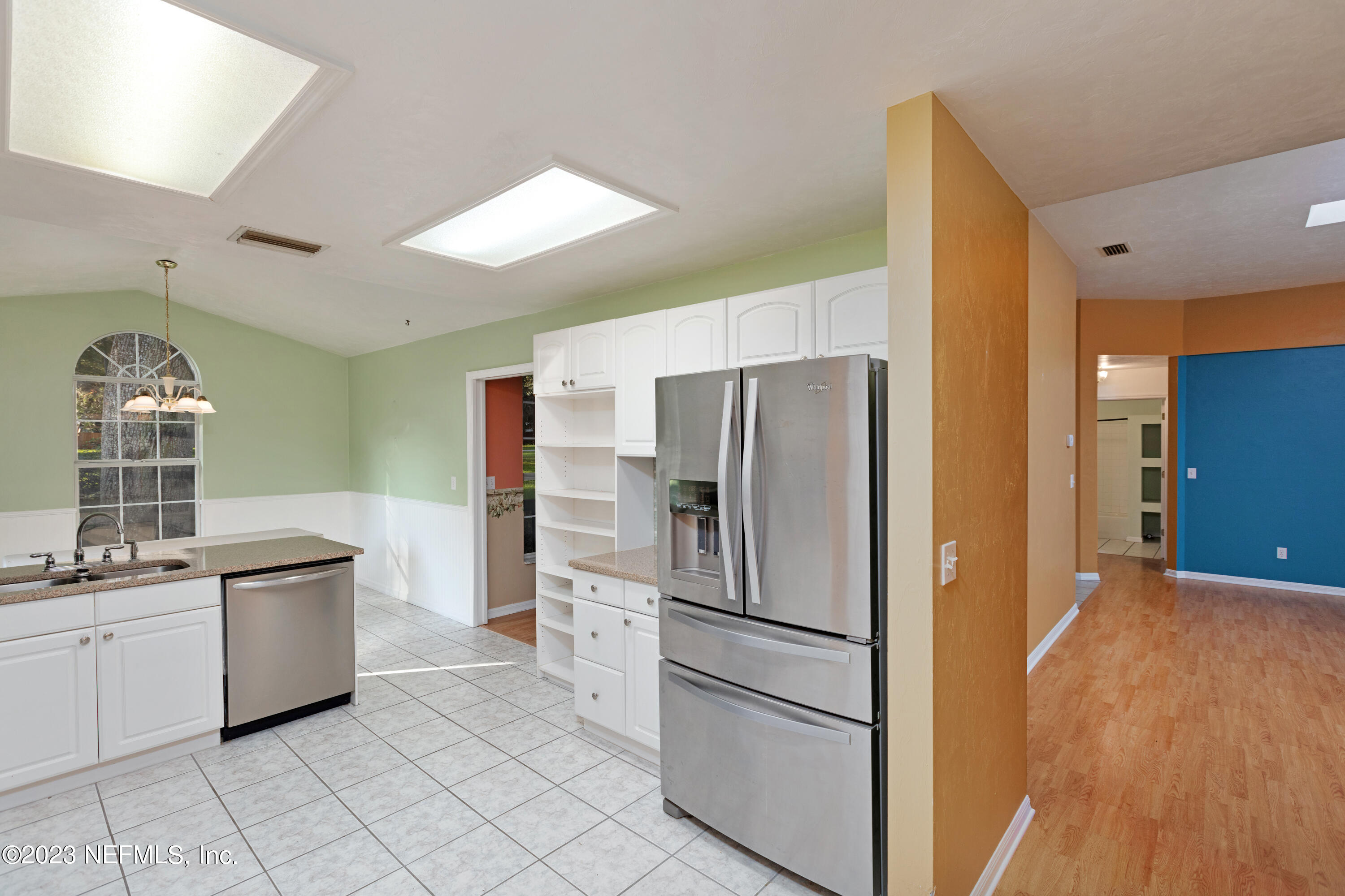 445 Southeast 28th Loop Melrose, FL 32666 - Photo 16 of 75 a kitchen with white cabinets and stainless steel appliances