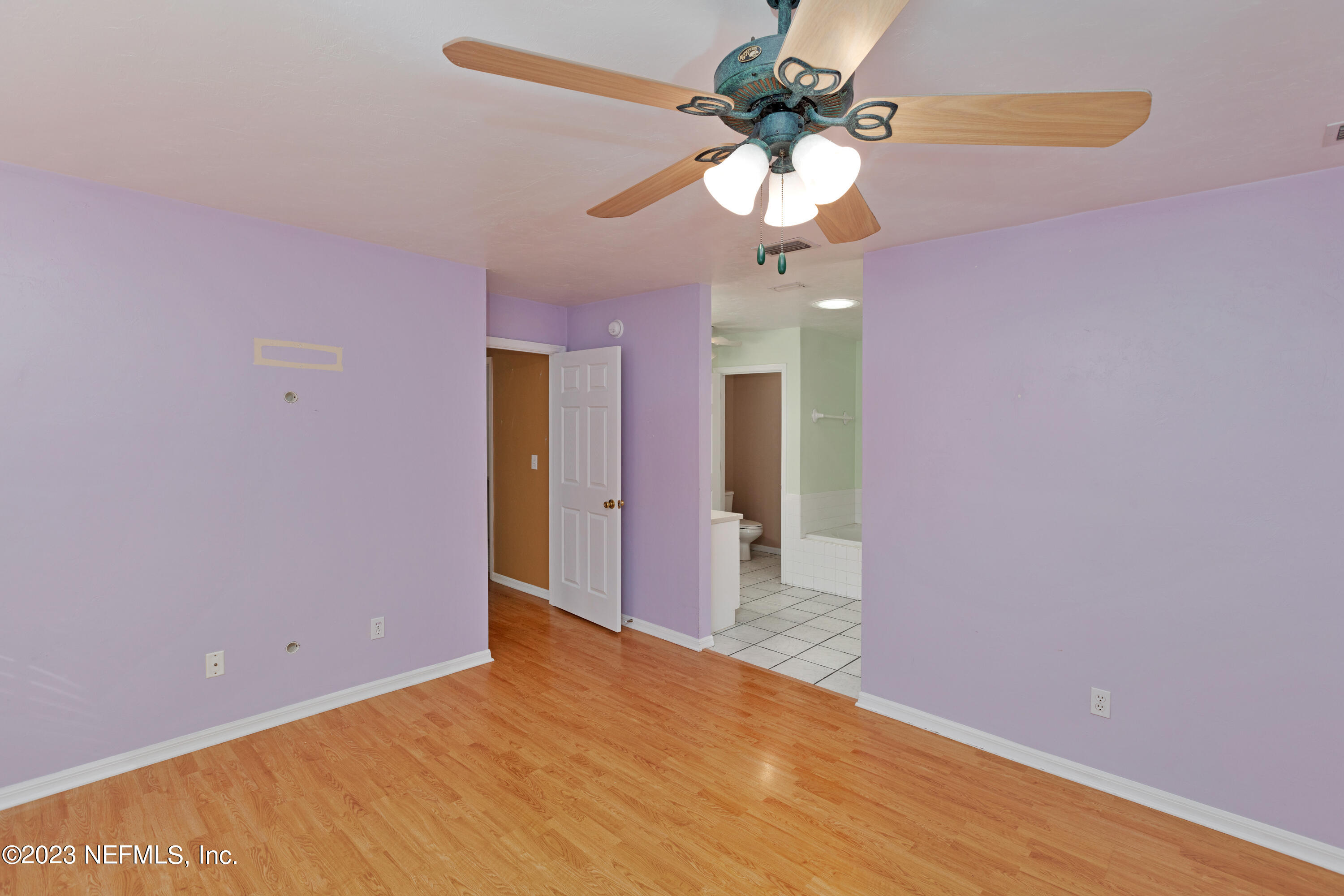 445 Southeast 28th Loop Melrose, FL 32666 - Photo 20 of 75 a view of an empty room with a chandelier fan