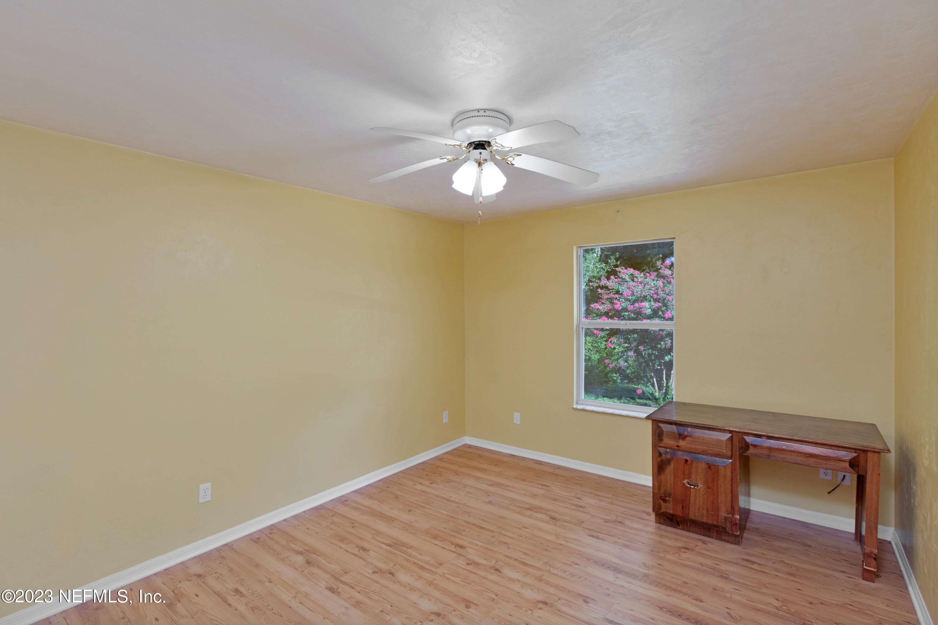 445 Southeast 28th Loop Melrose, FL 32666 - Photo 41 of 75 a view of an empty room with a window and wooden floor