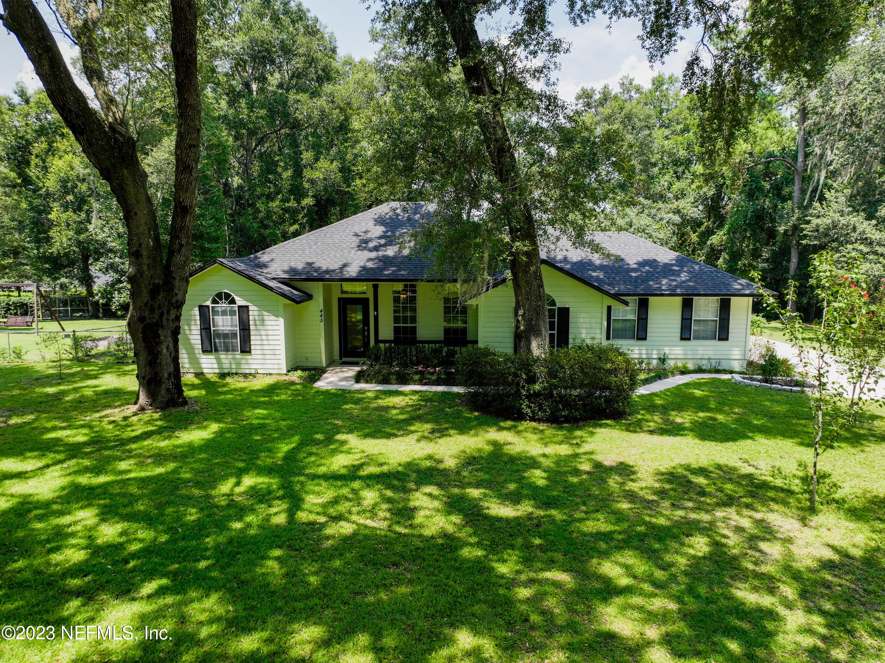 445 Southeast 28th Loop Melrose, FL 32666 - Photo 69 of 75 a front view of a house with a yard