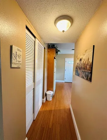 a view of a hallway with wooden floor