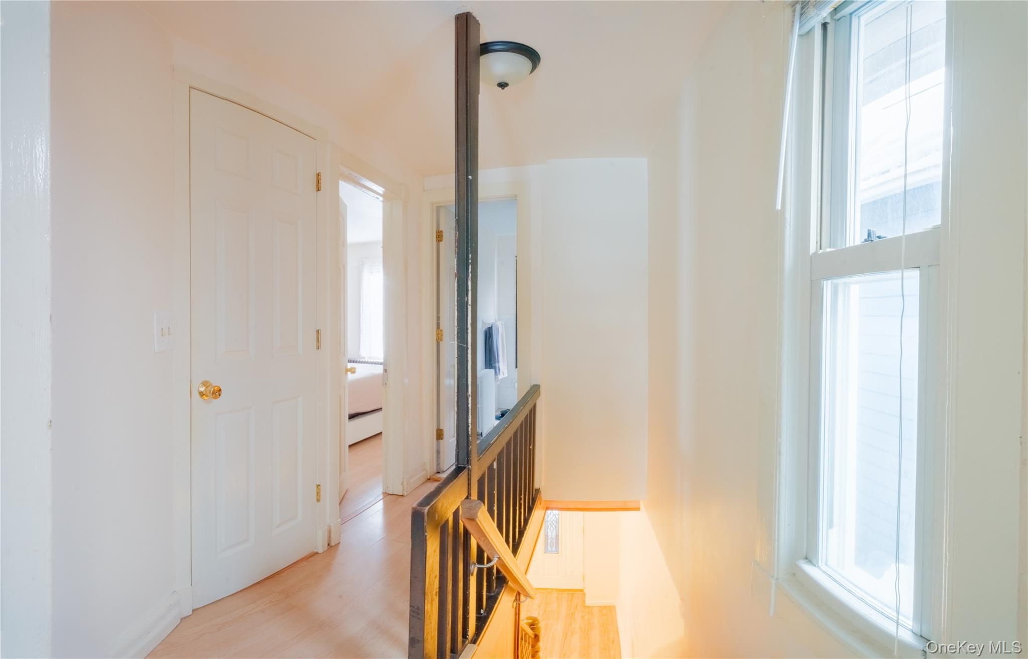 925 Constant Avenue Peekskill, NY 10566 - Photo 13 of 26 Hall featuring healthy amount of natural light, light wood-style floors, and an upstairs landing