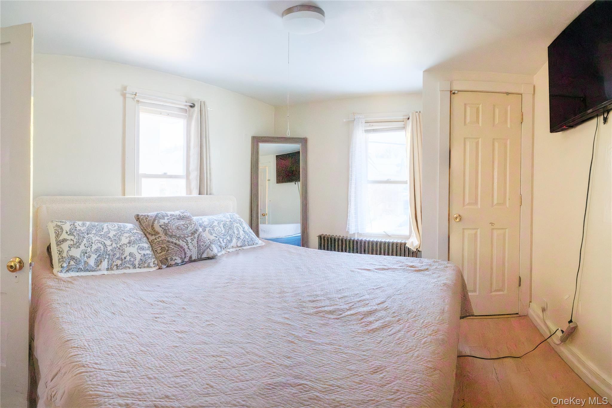 925 Constant Avenue Peekskill, NY 10566 - Photo 16 of 26 Bedroom featuring radiator heating unit and light wood-type flooring