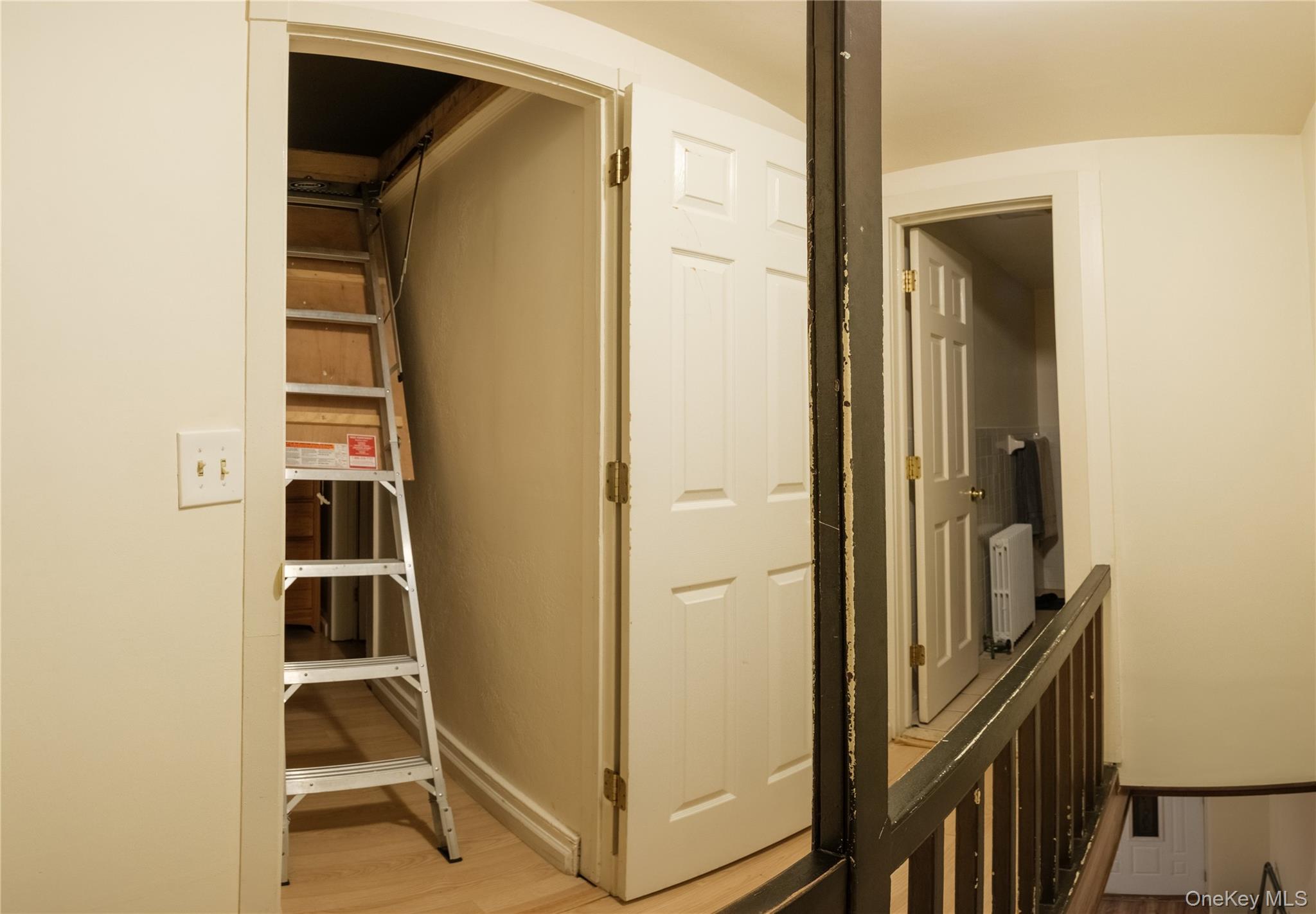 925 Constant Avenue Peekskill, NY 10566 - Photo 18 of 26 Hall with light wood-style floors, radiator heating unit, and arched walkways
