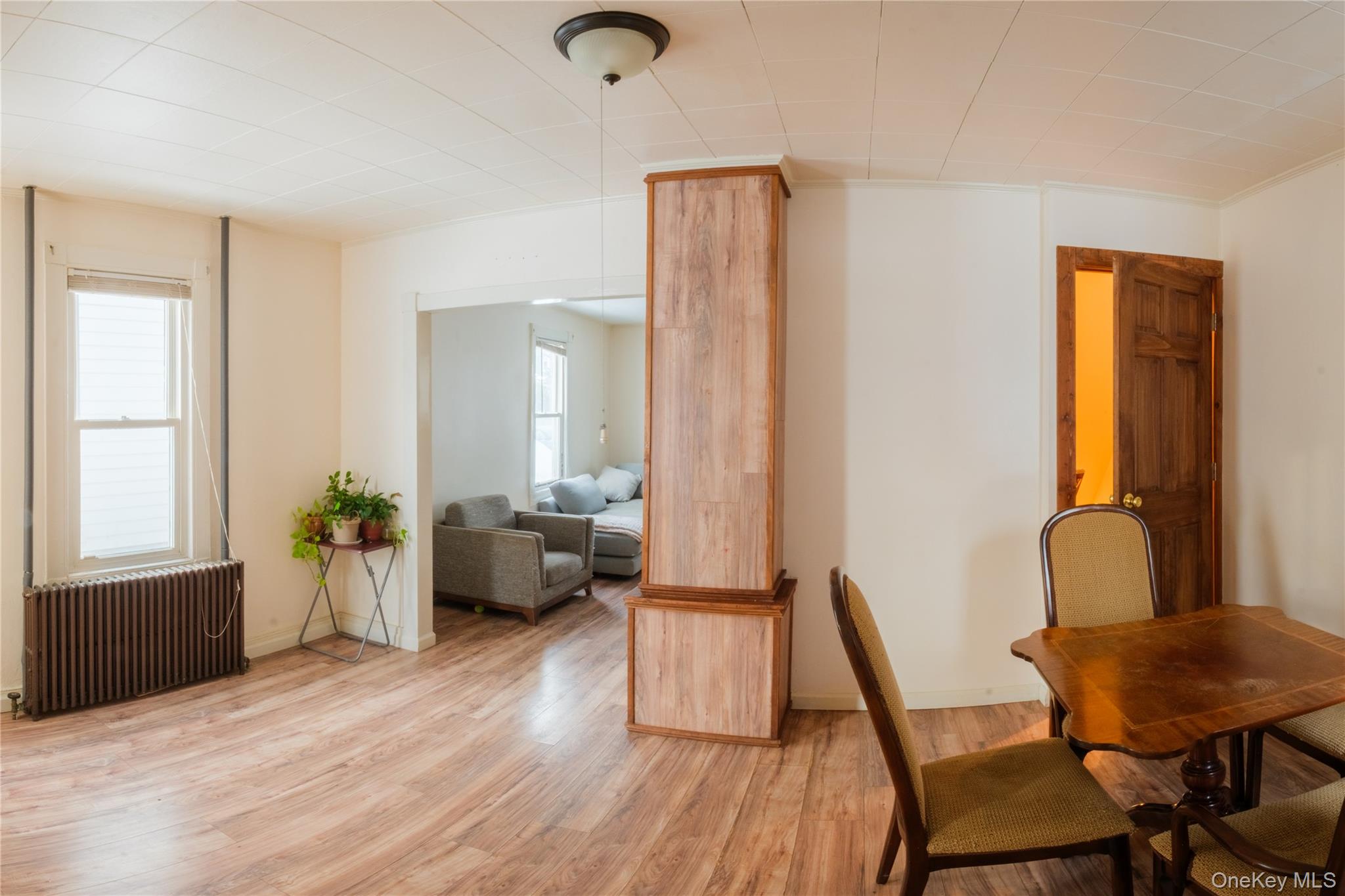 925 Constant Avenue Peekskill, NY 10566 - Photo 3 of 26 Dining space featuring radiator heating unit and wood finished floors