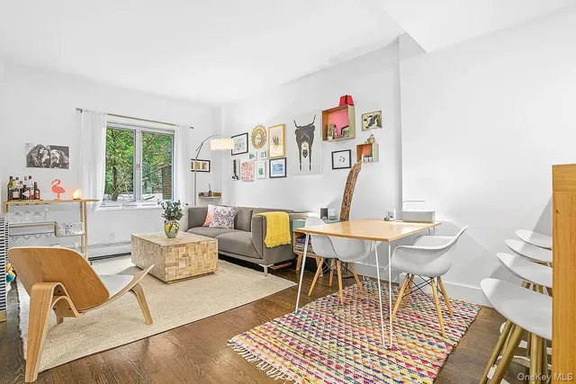 a living room with furniture a rug and a large window