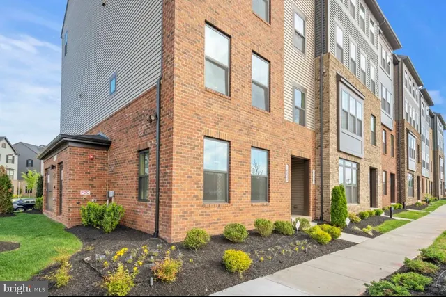 a view of a brick building next to a yard