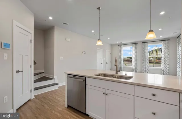a kitchen with a sink stove and wooden cabinets