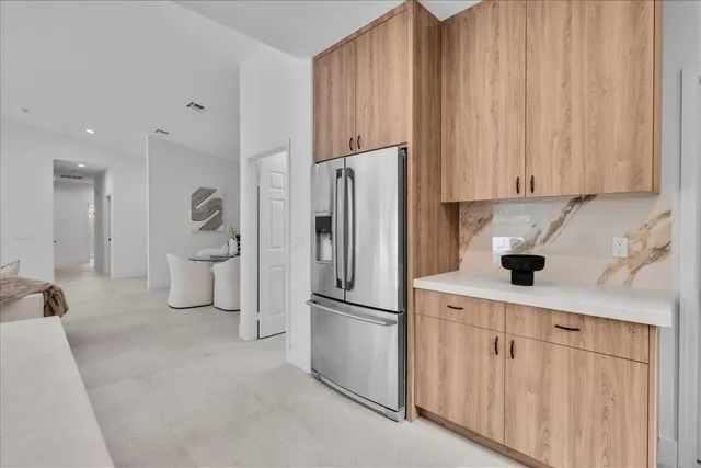 a bedroom with a bed a mirror and a large window