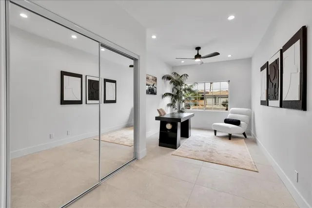 a view of a patio with couches table and chairs with wooden floor and fence