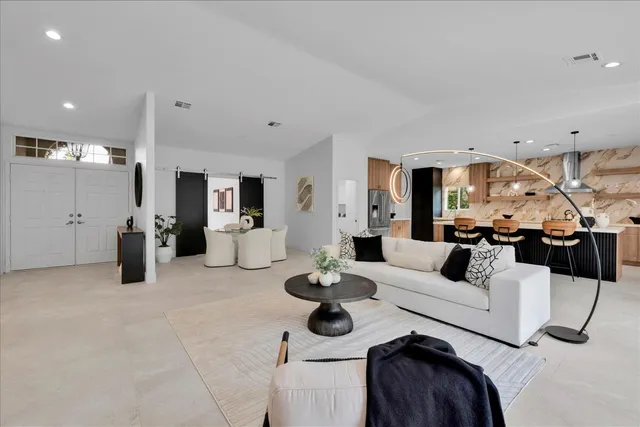 a living room with furniture and a large mirror