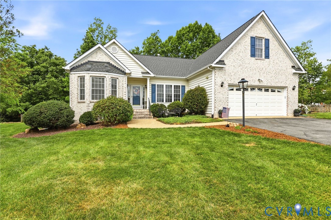 1700 Rolfield Way Henrico, VA 23238 - Photo 1 of 44 a front view of a house with a yard and potted plants