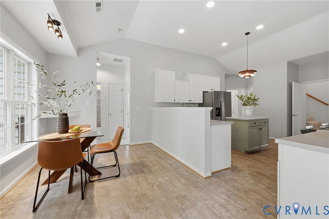 1700 Rolfield Way Henrico, VA 23238 - Photo 11 of 44 a kitchen with refrigerator a table and chairs