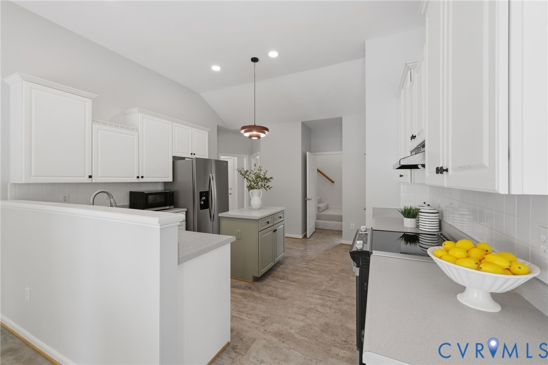 1700 Rolfield Way Henrico, VA 23238 - Photo 13 of 44 a kitchen with a sink a stove a refrigerator and white cabinets