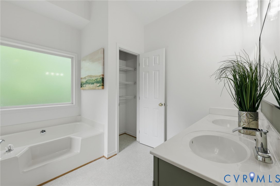 1700 Rolfield Way Henrico, VA 23238 - Photo 22 of 44 a bathroom with a sink a bathtub and a window