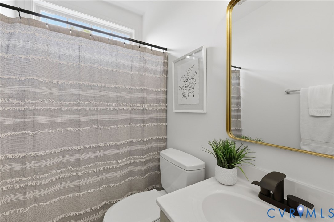 1700 Rolfield Way Henrico, VA 23238 - Photo 27 of 44 a bathroom with a shower curtain and a toilet