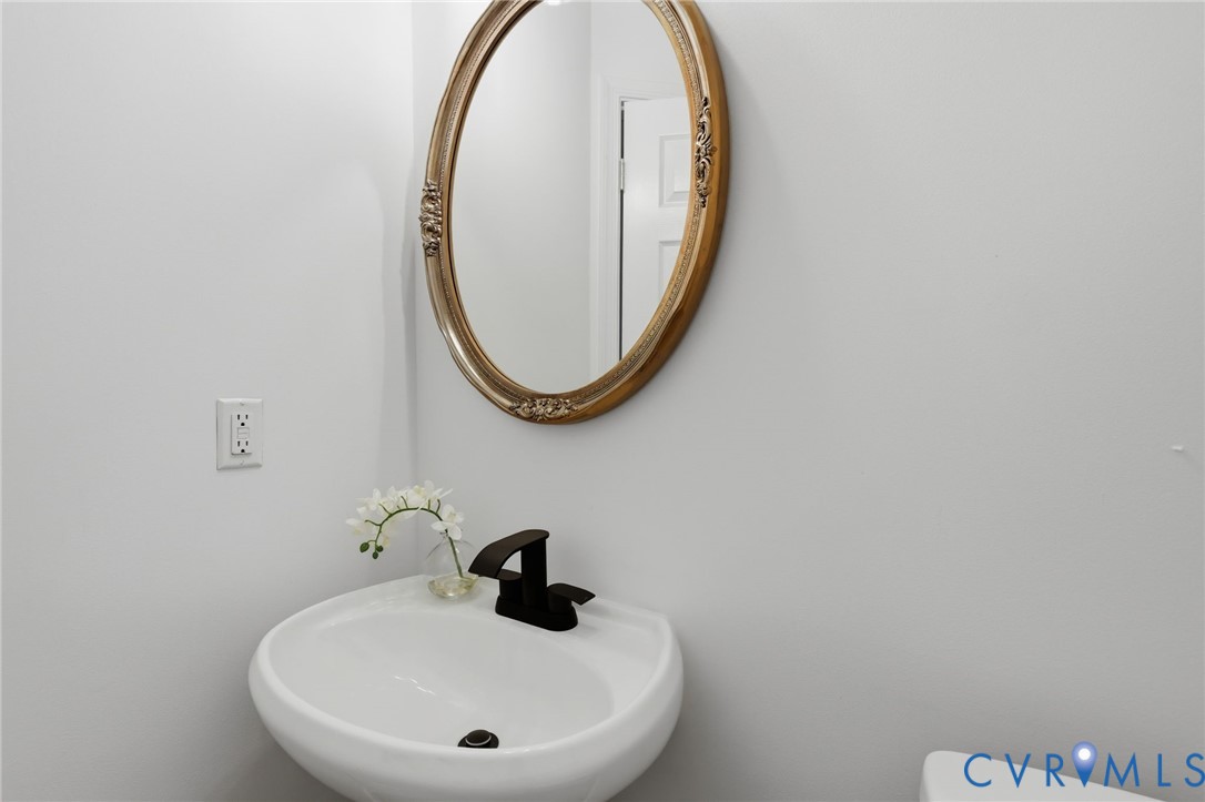 1700 Rolfield Way Henrico, VA 23238 - Photo 32 of 44 a bathroom with a sink and a mirror