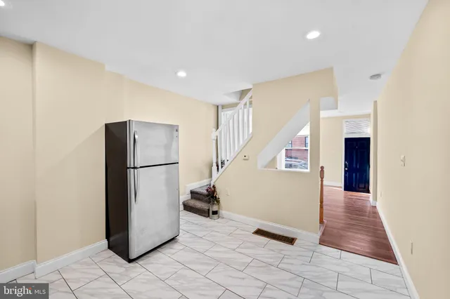 a view of entryway with furniture and a refrigerator