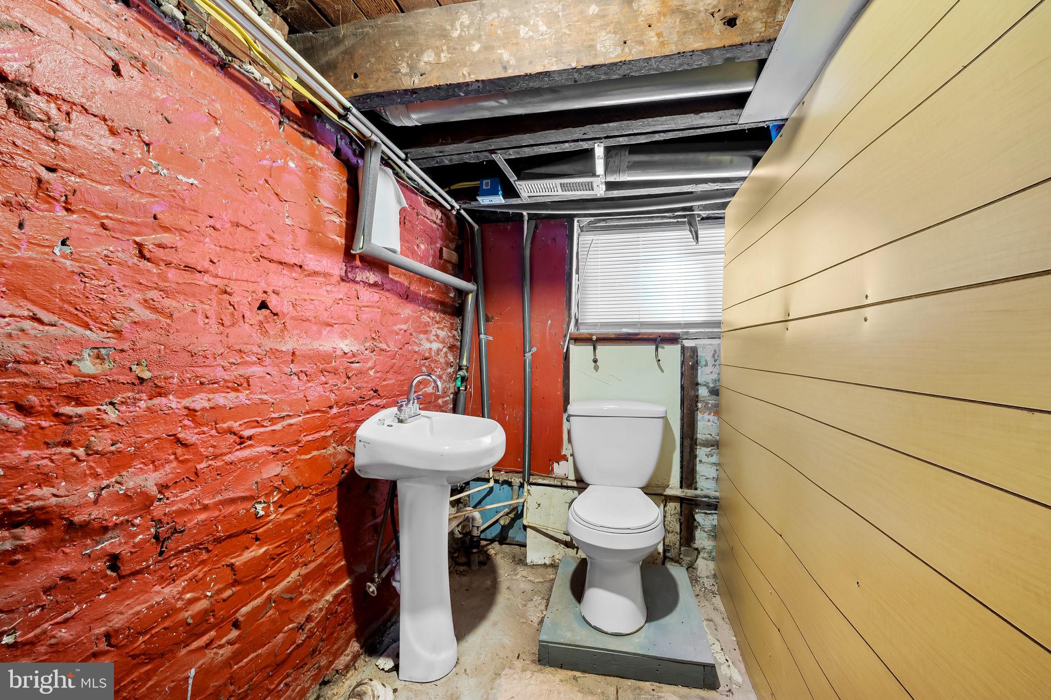 307 Fagley Street Baltimore, MD 21224 - Photo 21 of 24 a bathroom with a toilet and a shower