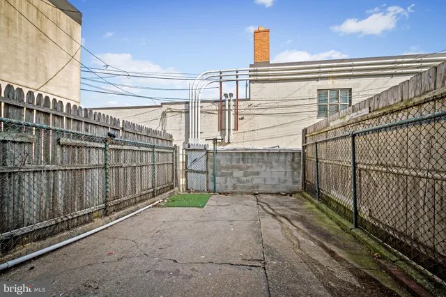 a view of a house with wooden fence