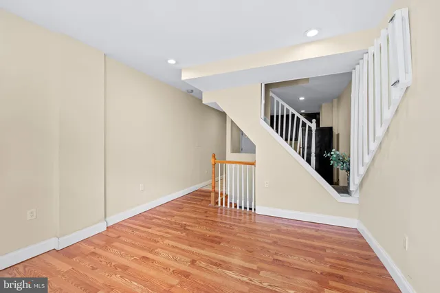 a view of entryway and hall with wooden floor