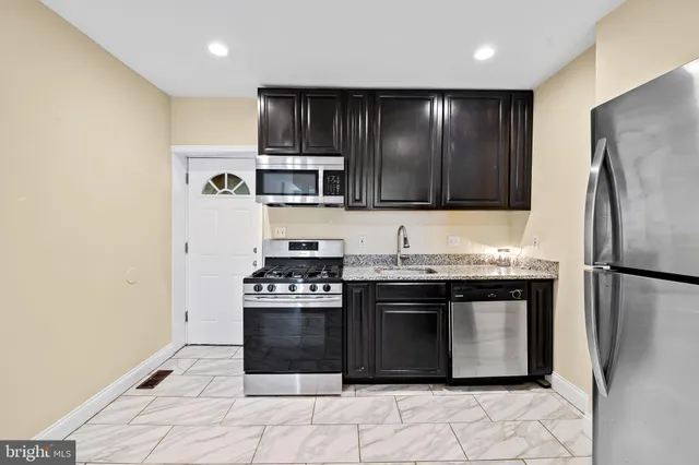 a kitchen with a stove and a refrigerator