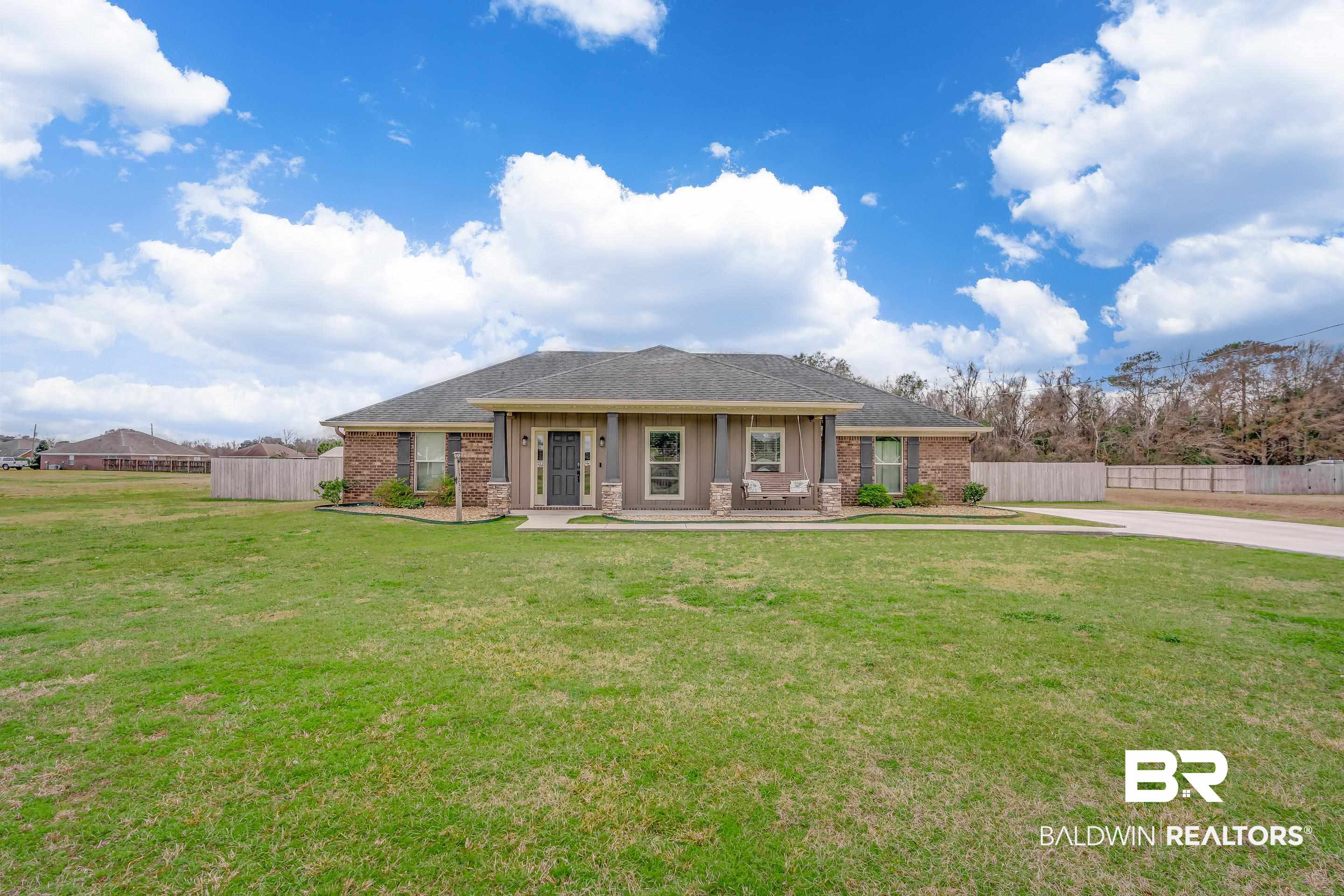 13235 Tom Gaston Road Mobile, AL 36695 - Photo 33 of 43 View of front of home with a front yard and covered porch