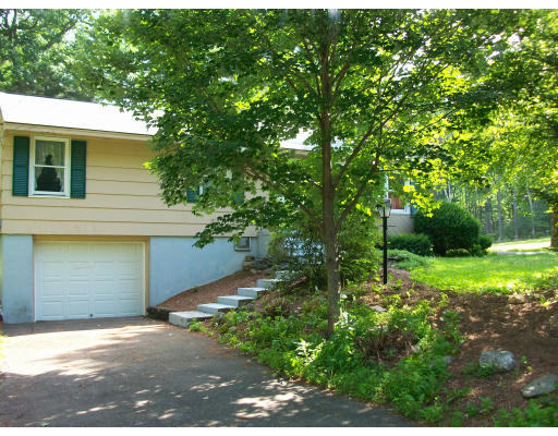 14 Miles Road Rutland, MA 01543 - Photo 2 of 2 a house that has a tree in front of it