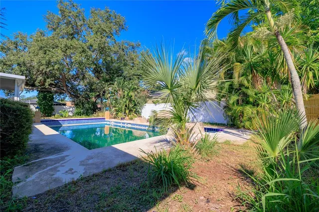a spacious bedroom with a bed and a wooden floor