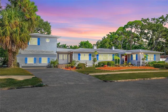 a front view of a residential houses with yard and green space