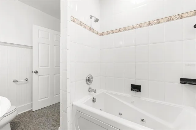 a white toilet sitting next to a white sink