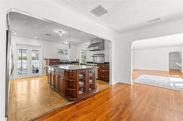 a large kitchen with stainless steel appliances granite countertop a stove and a refrigerator