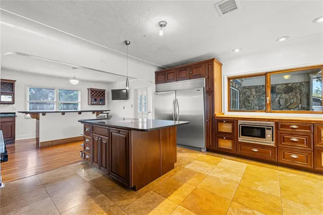a kitchen with stainless steel appliances granite countertop a sink and a stove