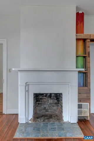 a living room with a fireplace and a rug