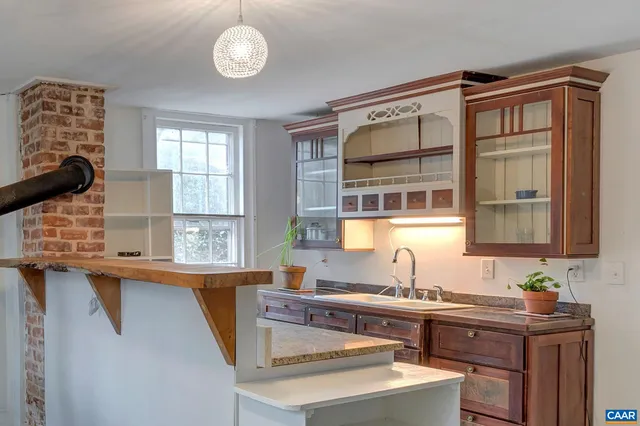 a kitchen with a sink cabinets and window