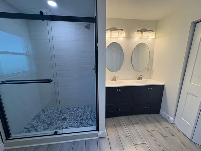 an empty room with windows and ceiling fan