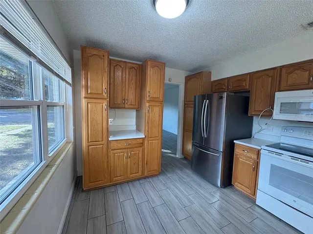 a kitchen with stainless steel appliances a refrigerator and a stove