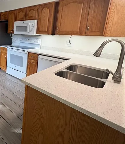 a kitchen with a sink and a refrigerator