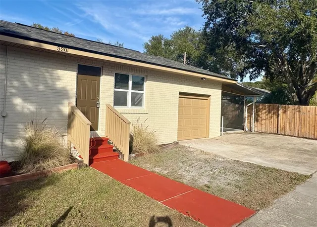 a view of a house with a backyard