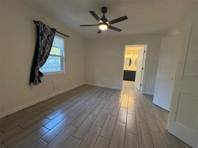 wooden floor in an empty room with a window