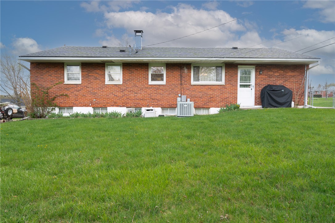 795 Spring Garden Place Dayton, OH 45431 - Photo 13 of 34 This classic brick residence features a spacious yard and inviting back entrance, perfect for relaxed outdoor living.