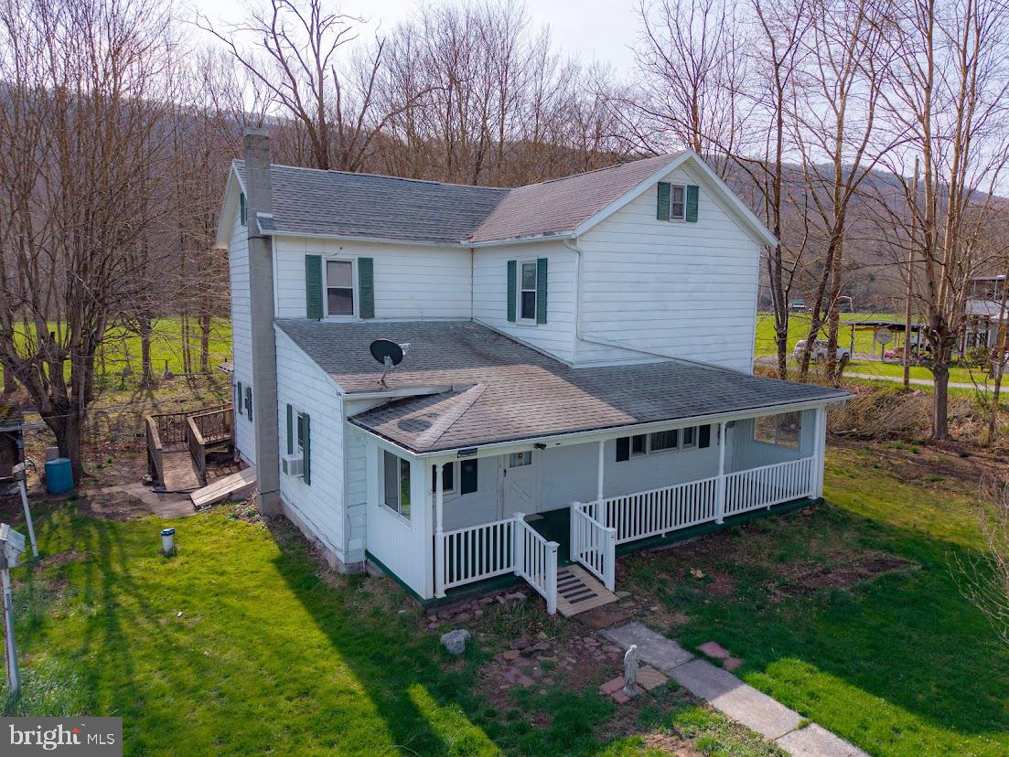 a view of a house with backyard and porch
